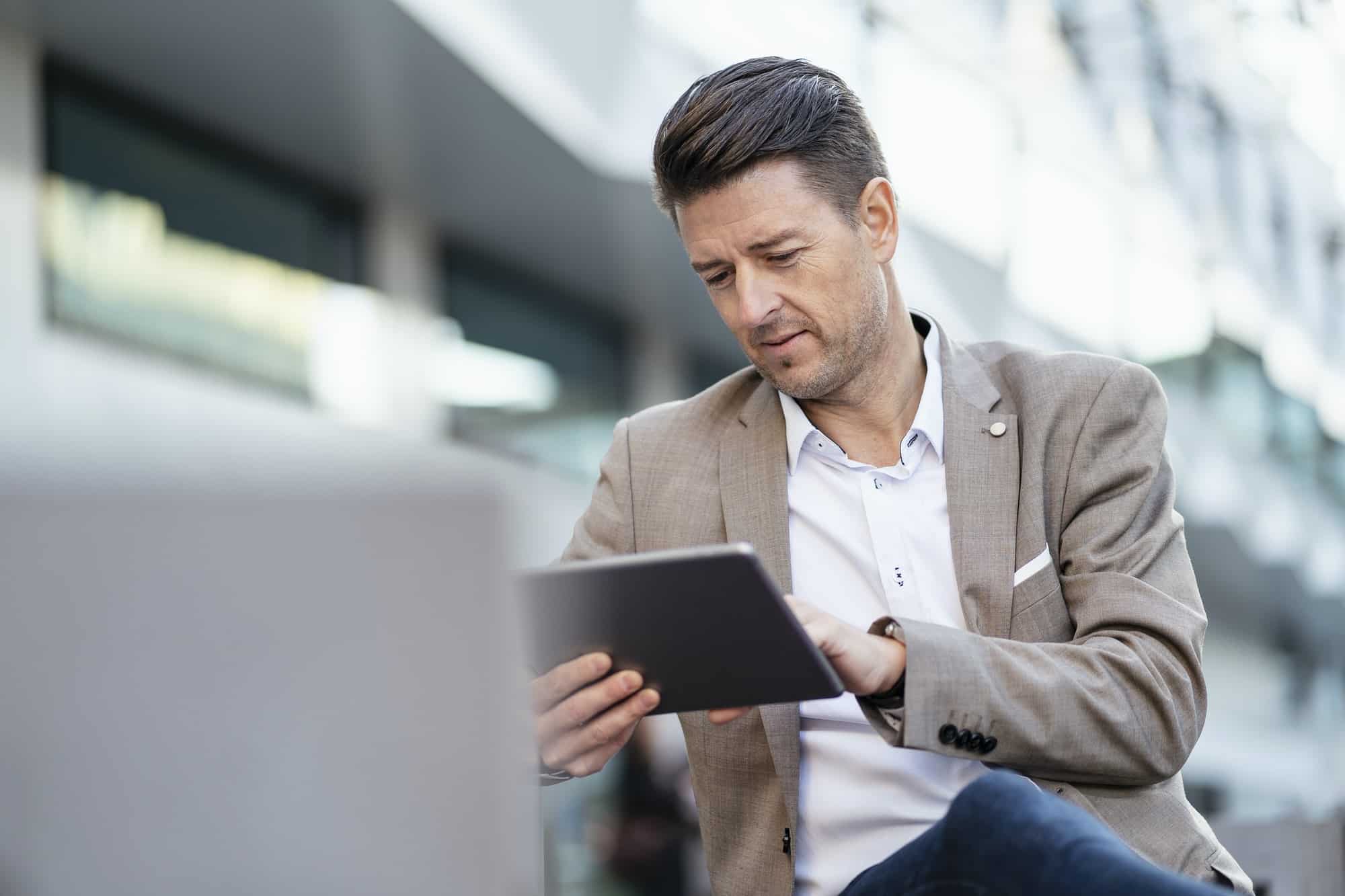 Businessman using tablet outdoors